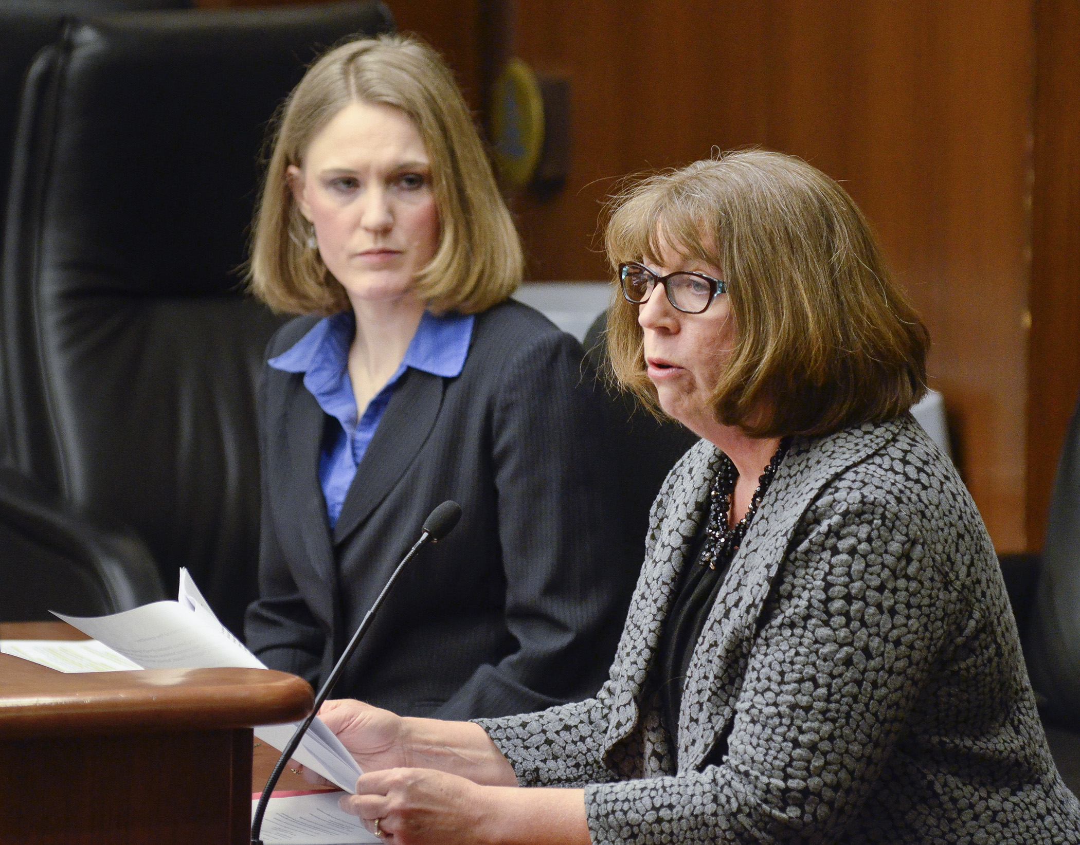 Patrice O’Leary, senior director of youth, housing & family resources at Lutheran Social Service of Minnesota, testifies Feb. 18 in support of a bill sponsored by Rep. Anna Wills, left, that would modify the Homeless Youth Act. Photo by Andrew VonBank. 